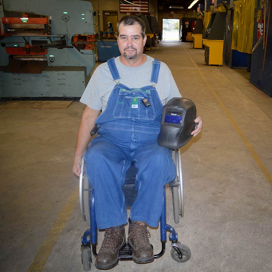 Welding student navigating the classroom in a wheelchair