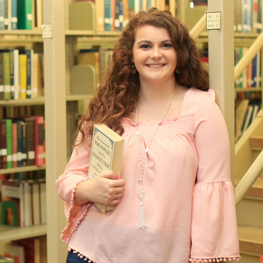 Girl holding a book in the library