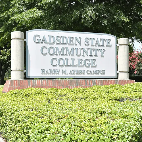Campus signage outside with bushes