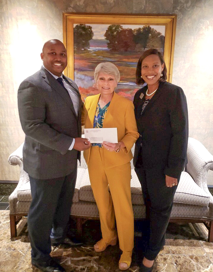 Dr. Bryant Cline, the director of Health Programs at Alabama Community College System and a member of Omega Psi Phi Fraternity, presents a check to Dr. Kathy Murphy, president of Gadsden State, and Dr. Aletta Williamson, former dean of Enrollment and Retention at Gadsden State